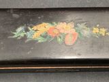 a small black box with a floral design on it