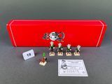 a red box with a toy figure and a card on it