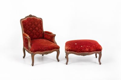 pair of red upholstered chairs and a foot stool