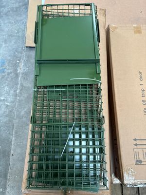 a box with a cage on top of it next to a box with a bird in it