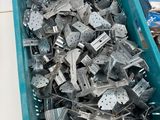 a blue container filled with metal parts on a table