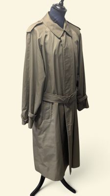 trench coat on a mannequin stand on a white background