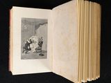 an open book with a picture of a man and a woman sitting on a chair
