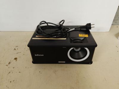 a small black object on the floor next to a white wall
