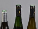 three bottles of wine sitting next to each other on a table
