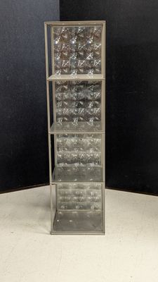 an image of a tall metal shelf with glass bottles on it