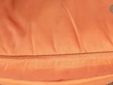an orange backpack with a zipper on the front and a zipper on the back