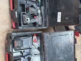 three tools in a case sitting on the ground next to each other