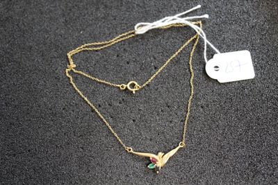 Gros plan sur un collier orné d'un oiseau
