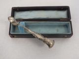 a silver spoon sitting in a box on a table