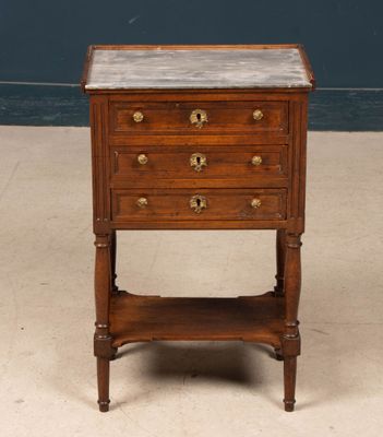 a small wooden table with a marble top on it