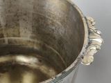 a silver pot that is sitting on a table