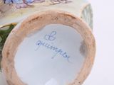 a close up of a vase with writing on it