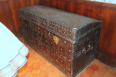 an old trunk sitting in the corner of a room