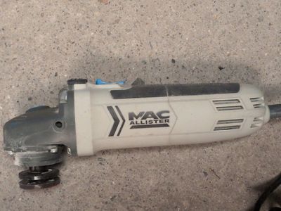 an image of a drill on the ground next to a pair of shoes