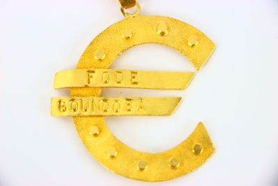 a gold pendant with a euro sign on it