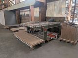 many pieces of wood on the floor in the warehouse
