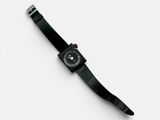 black watch on a white surface with a white background