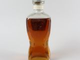 a bottle of syrup sitting on a white surface