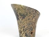 a close up of a vase on a white surface