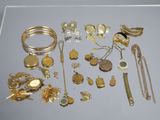 a lot of gold jewelry on display on a table