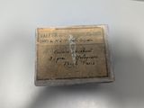 an old piece of paper with writing on it sitting on a table