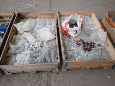 two wooden boxes filled with assorted items sitting on the ground