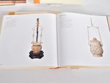 an open book on a table with a picture of a lamp on it