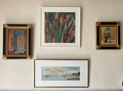 many pictures on the wall above a couch