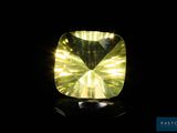 a close up of a yellow diamond on a black surface