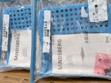 two bags of sandblaers sitting on top of a cardboard box