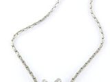 a close up of a silver necklace with a heart on it