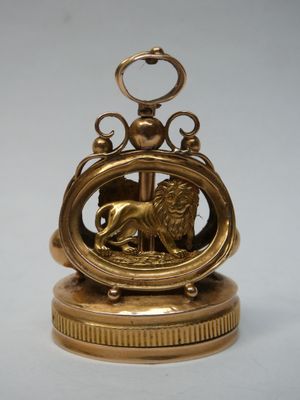 an antique brass clock with a lion on top of it
