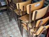 six wooden chairs sitting in a row in a room