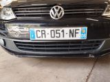 a black car parked in a garage with a license plate on the front