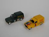 two toy trucks that are next to each other on a table