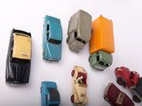 several toy cars are arranged in a circle on a white surface