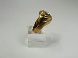 an image of a gold ring sitting on top of a clear stand