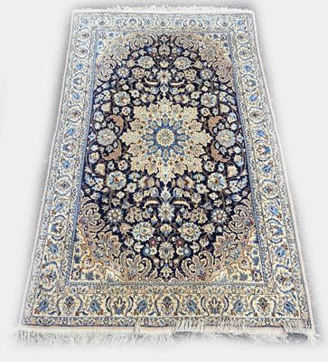 a black and blue rug with a floral design on it