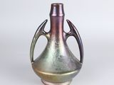 a metallic vase with a handle on a white background