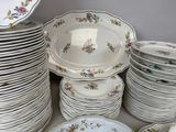 a lot of plates and bowls sitting on a table