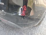 a reflection of a fire hydrant on the back of a car