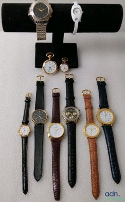 several different types of watches are displayed on a display stand