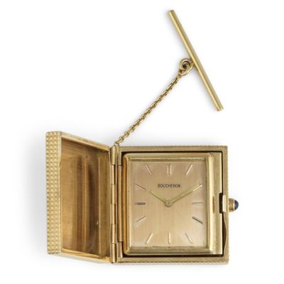 an image of a gold watch with a chain hanging from it ' s side