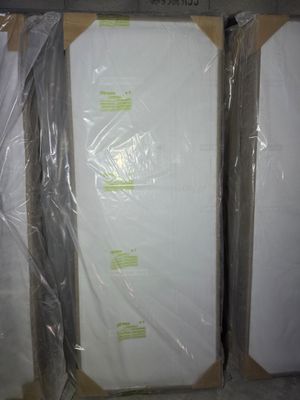 two boxes of mattresses wrapped in plastic on the floor
