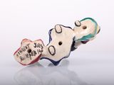 a small piece of pottery that has been made to look like a guitar
