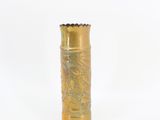 a gold vase with a dragon on it on a white surface