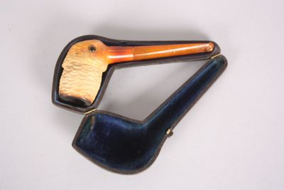 a picture of a brooch of a duck with a pipe in its mouth