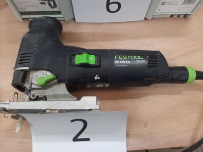 a black and green electric sander on a table