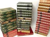 many books stacked on top of each other on a table